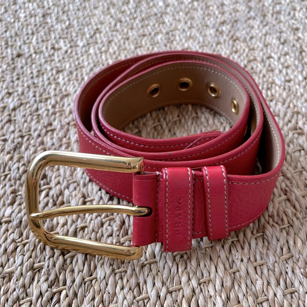 PRADA. Fiery red leather belt with metal buckle and notches. Size: 90.